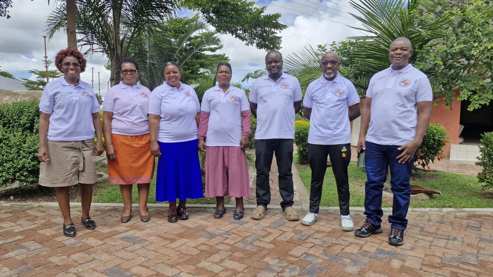 Team members posing together at the same event